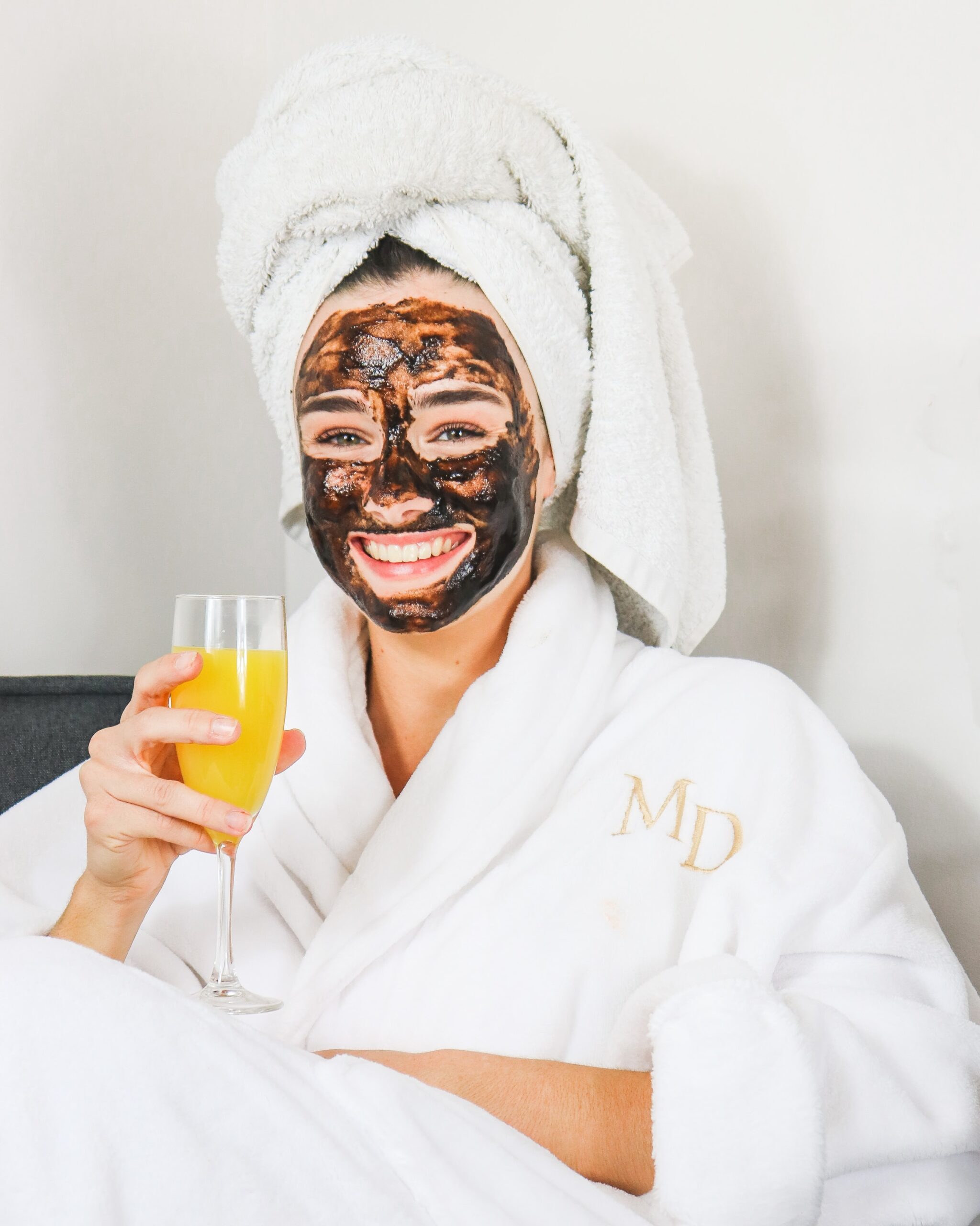 Bride to be, in a robe with a face mask on and getting pampered.