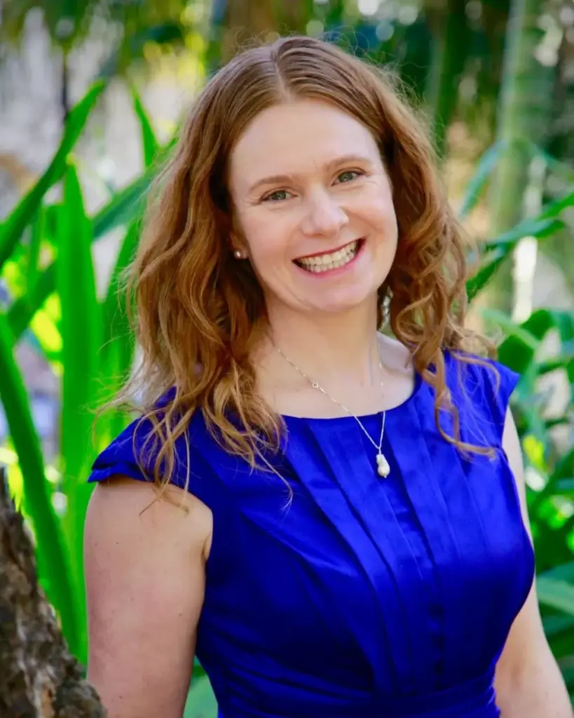 Valerie Murphy from Vows by Val, wearing a cobalt blue dress and smiling at the camera.