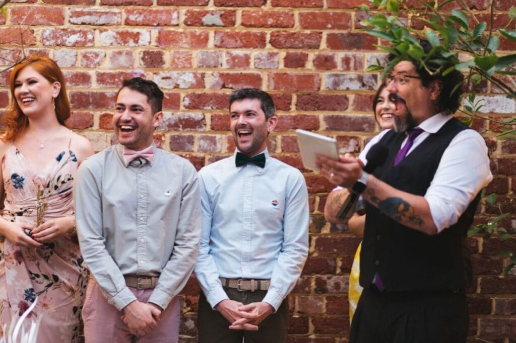 Eddie Lemos Couto Celebrant standing with the wedding party smiling