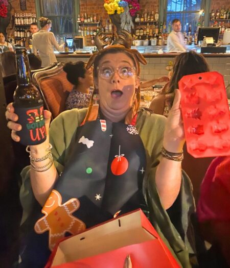 Jo Booth wasted no time donning her gay apparel – a Christmas-themed apron accompanied by equally festive ice tray and stubby cooler